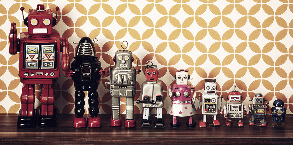 Retro style photography of a group of tin toy robots on a shelf.